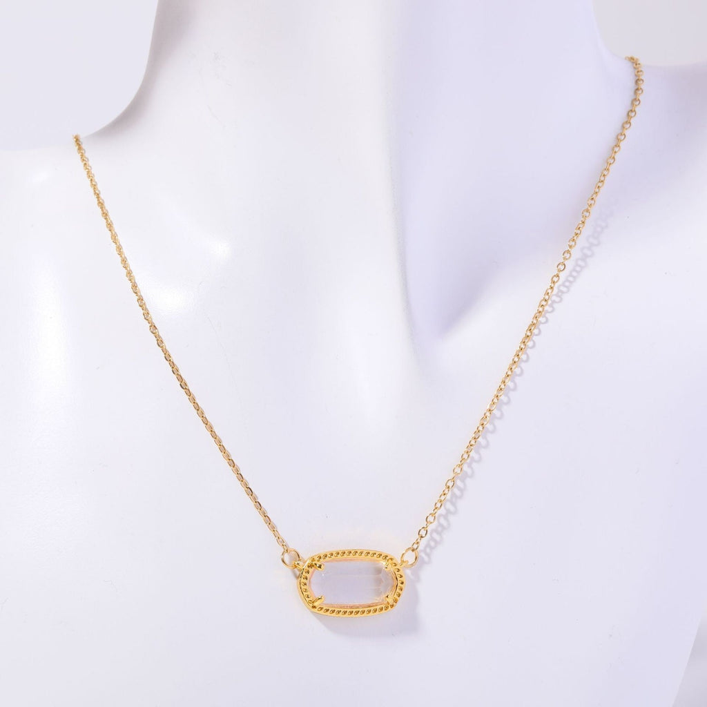 Gold necklace on a mannequin with a white background