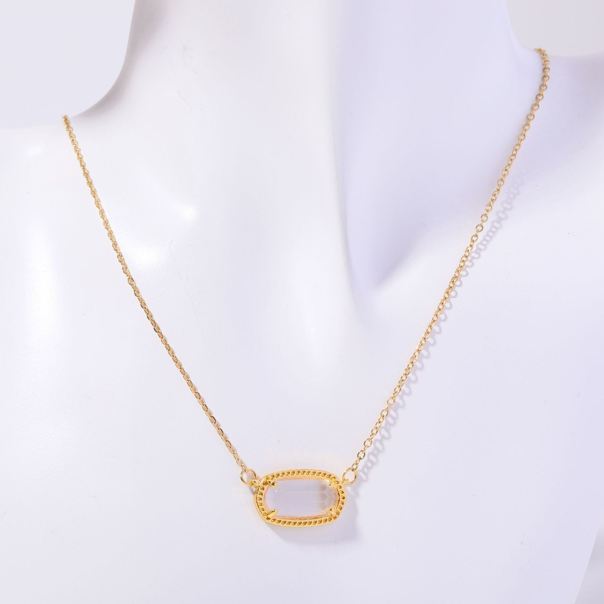 Gold necklace on a mannequin with a white background