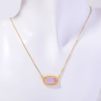 Necklace with a pink pendant on a mannequin against a white background
