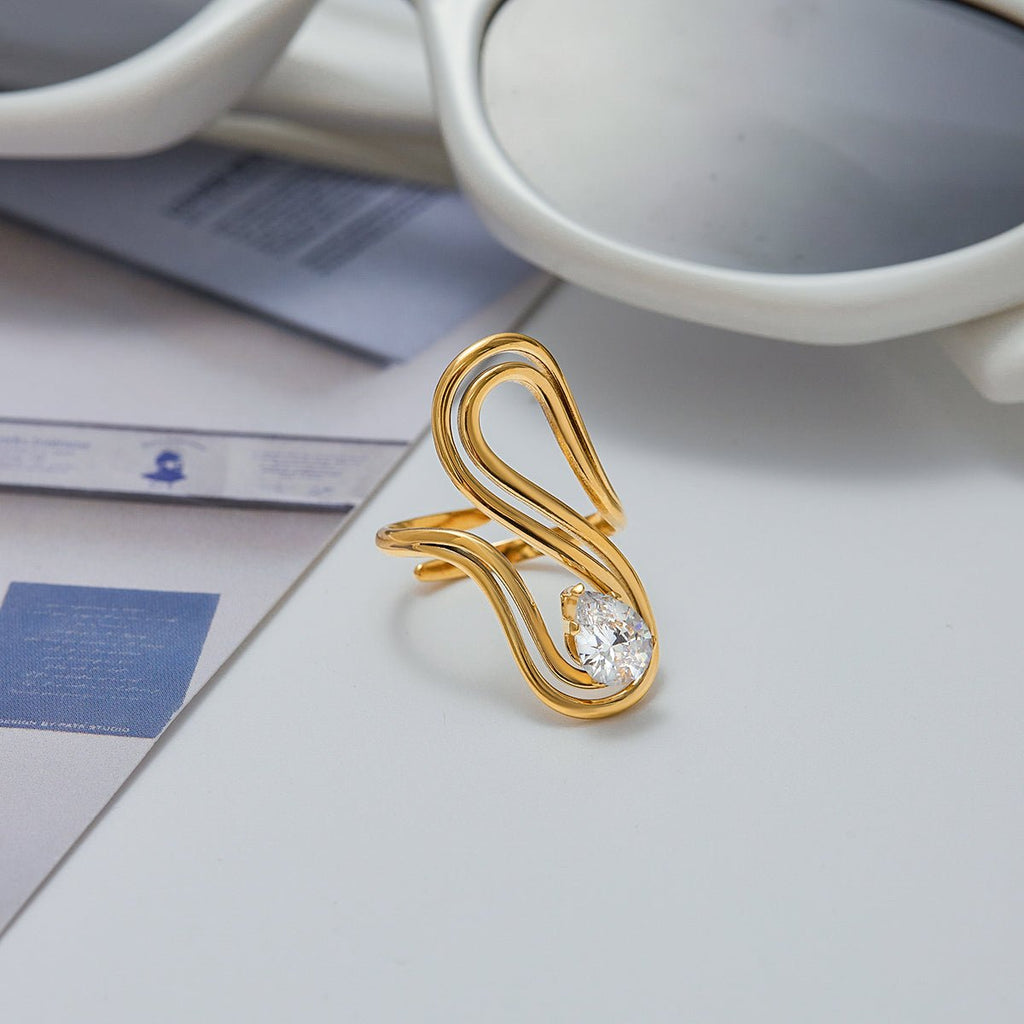 Gold ring with a diamond on a light surface