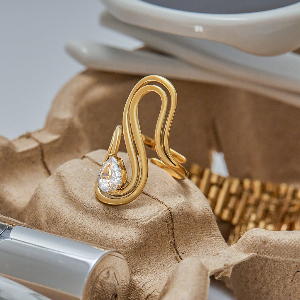 Gold ring with a diamond on a textured surface