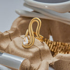 Gold ring with a diamond on a textured surface