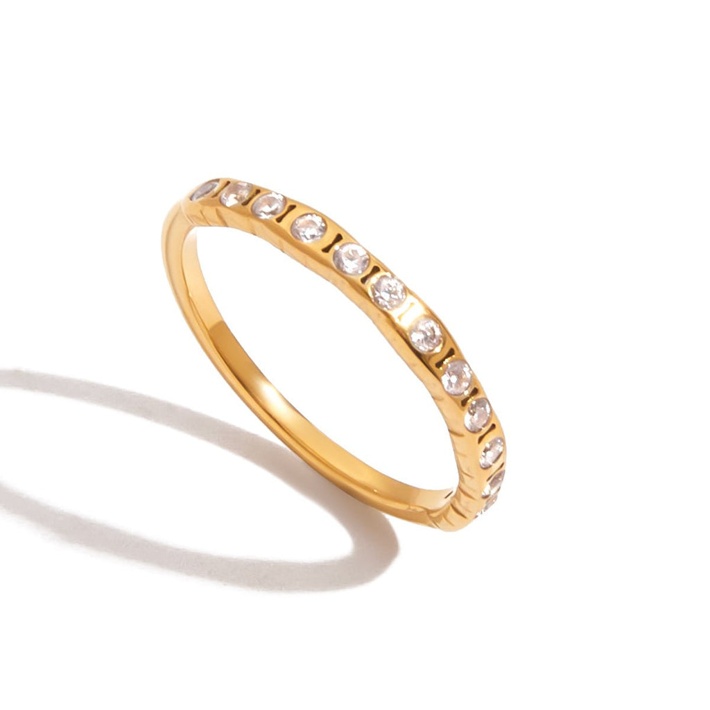Gold ring with small diamonds on a white background