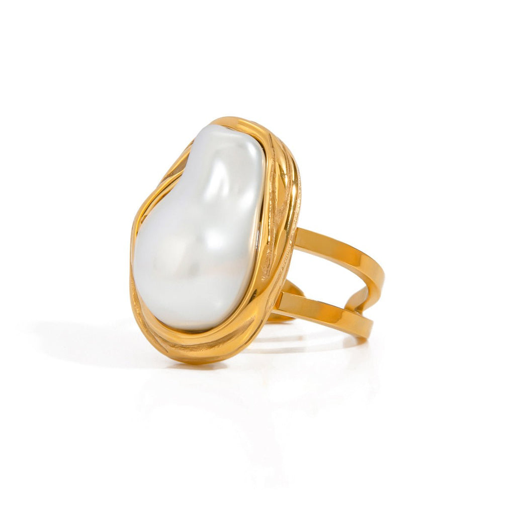 Gold ring with a large white pearl on a white background