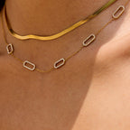 Gold necklace with a clear gemstone worn on an neck Minimalist rectangular link necklace in gold

