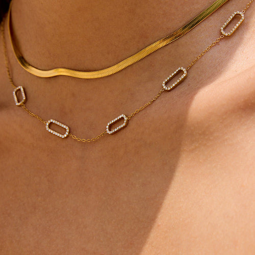 Gold necklace with a clear gemstone worn on an neck Minimalist rectangular link necklace in gold

