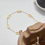 Gold necklace on a textured surface with a blurred background