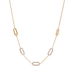 Gold necklace with geometric links on a white background