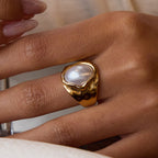 Gold and green gemstone jewelry set on a light background