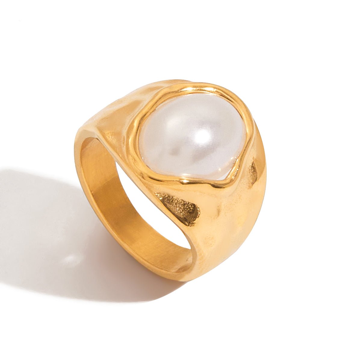 Gold ring with a pearl on a white background