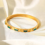 Emerald baguette stone bracelet in gold tone