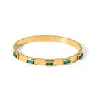 Minimalist bangle bracelet with green baguettes