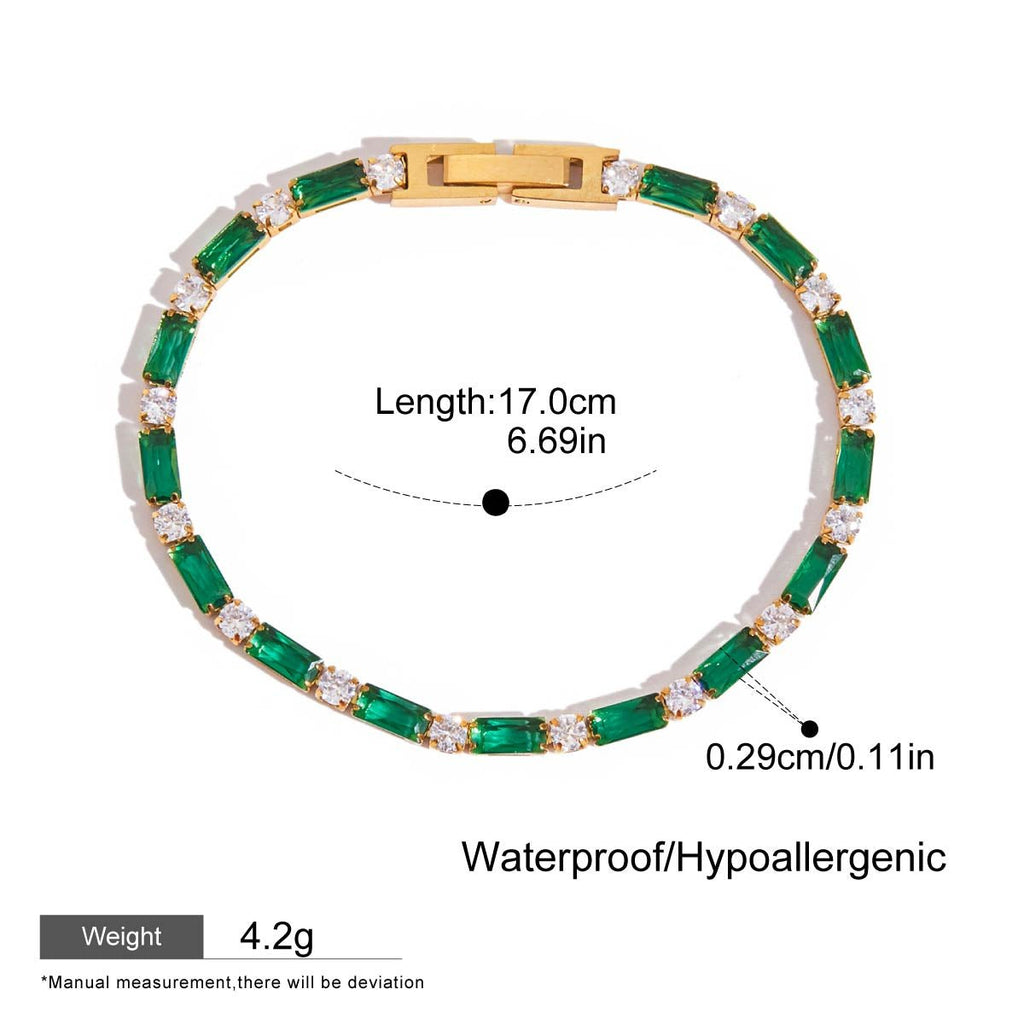 Gold tennis bracelet with baguette emeralds and round white gems

