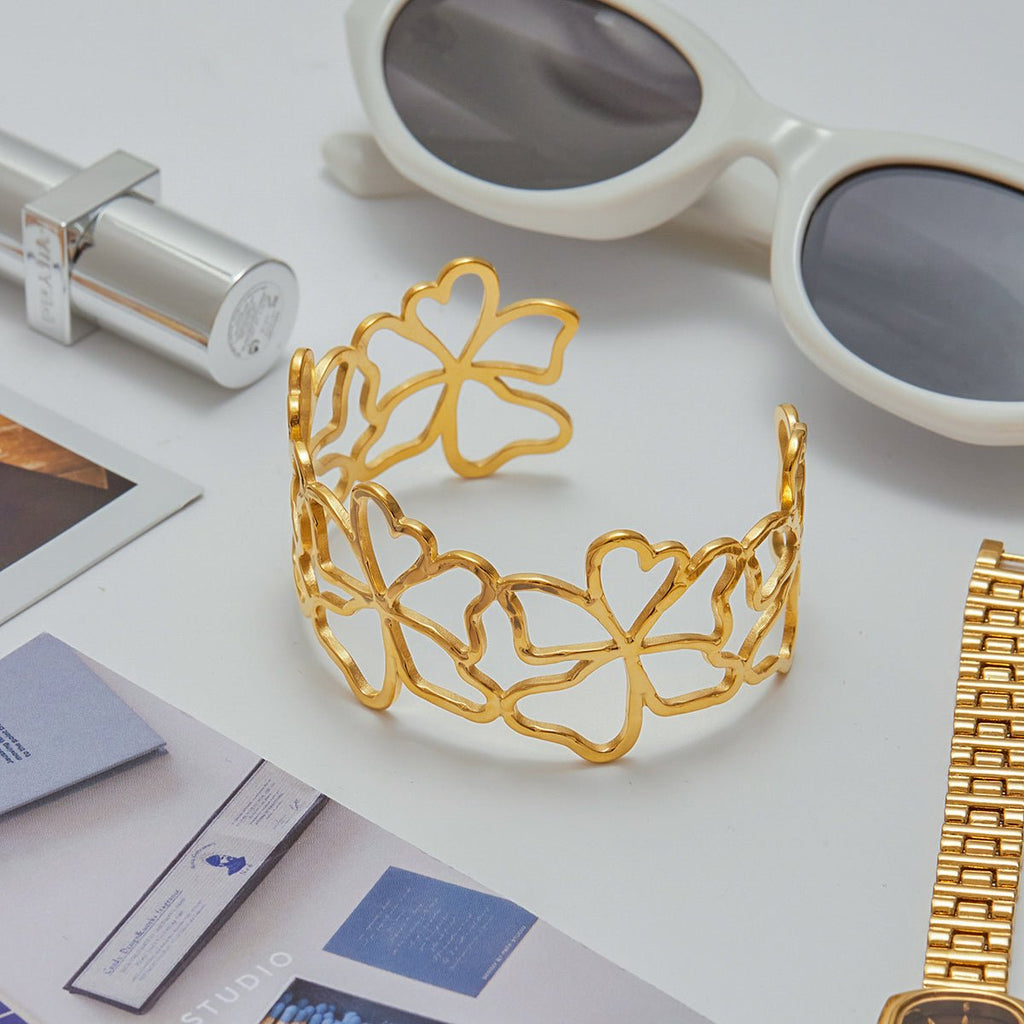 Romantic gold cuff bracelet with flower motifs