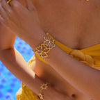 Heart-petal gold bracelet on the model's hand