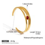 Artistic flat lay of gold garnet cuff bracelet