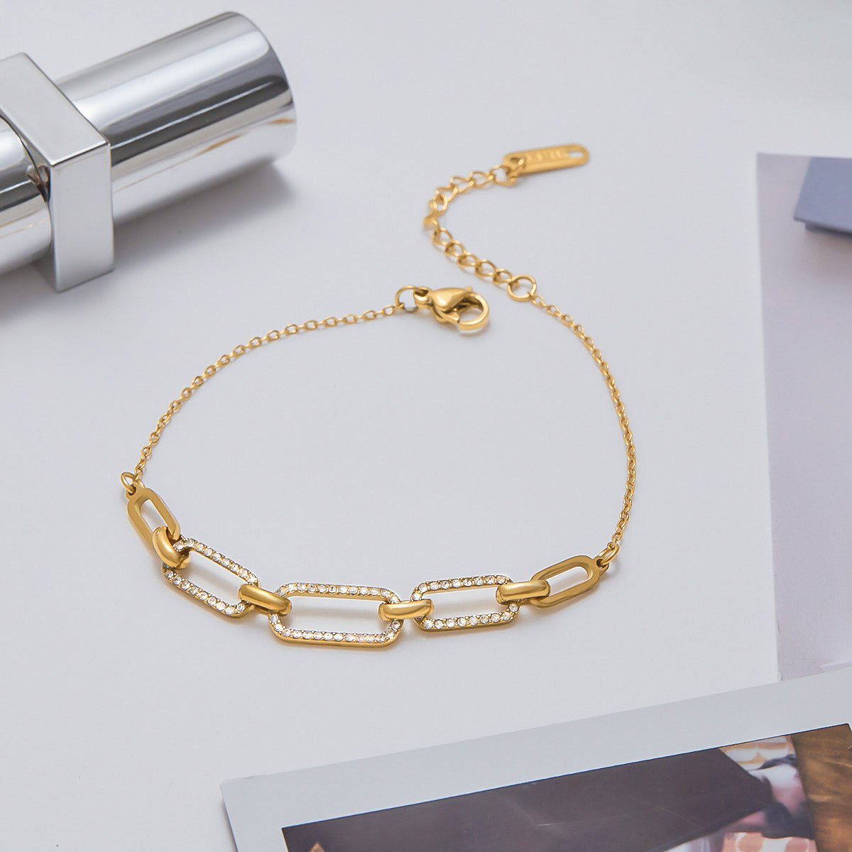 18K gold bracelet flat lay with accessories