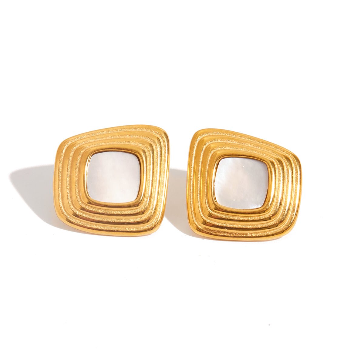 Pair of gold square earrings with a white center on a white background Elegant gold and pearl stud earrings for women

