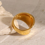 Gold ring on a textured stone surface