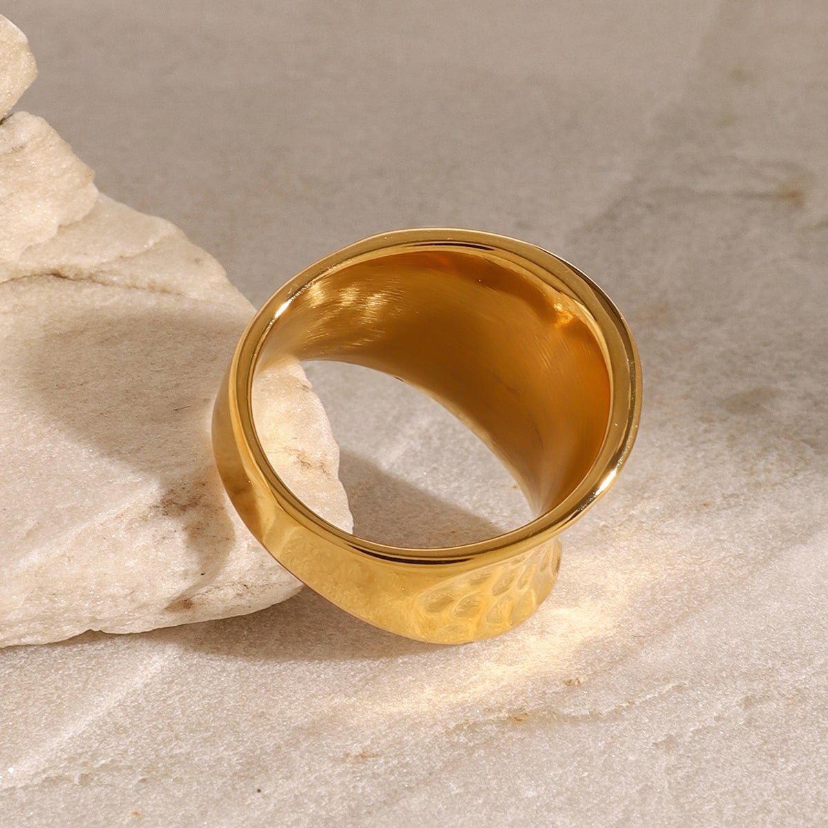 Gold ring on a textured stone surface