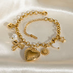 Gold bracelet with various charms on a white background