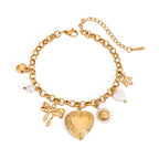 Gold bracelet with various charms on a white background