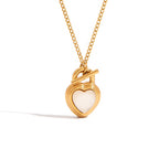 Gold heart-shaped necklace with a white heart pendant on a white background