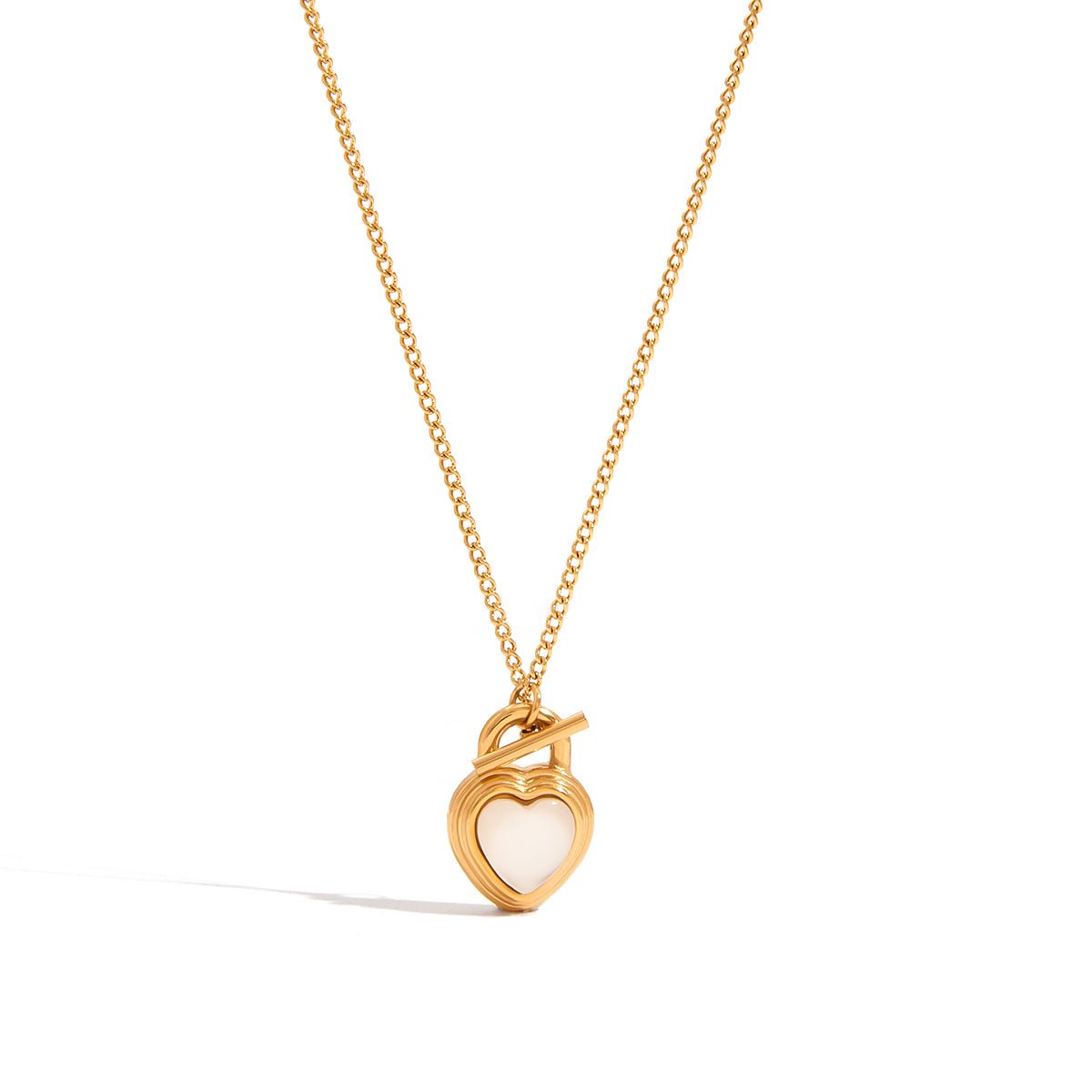 Gold necklace with a heart-shaped pendant on a white background
