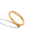 Gold ring with three diamonds on a white background