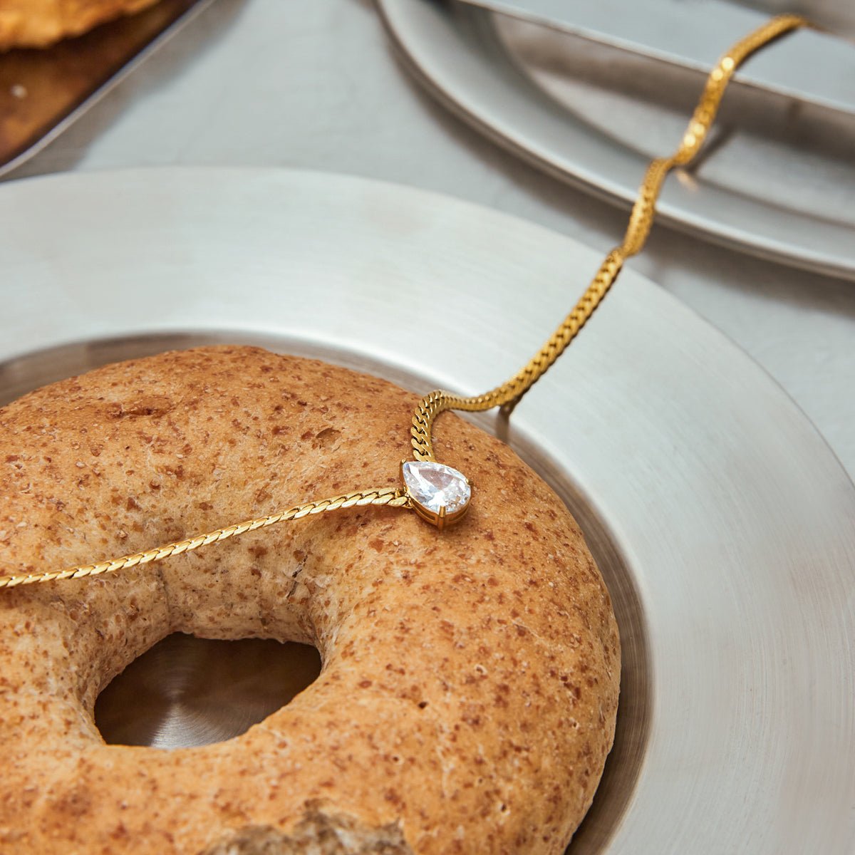 Gold necklace with a diamond pendant on a donut