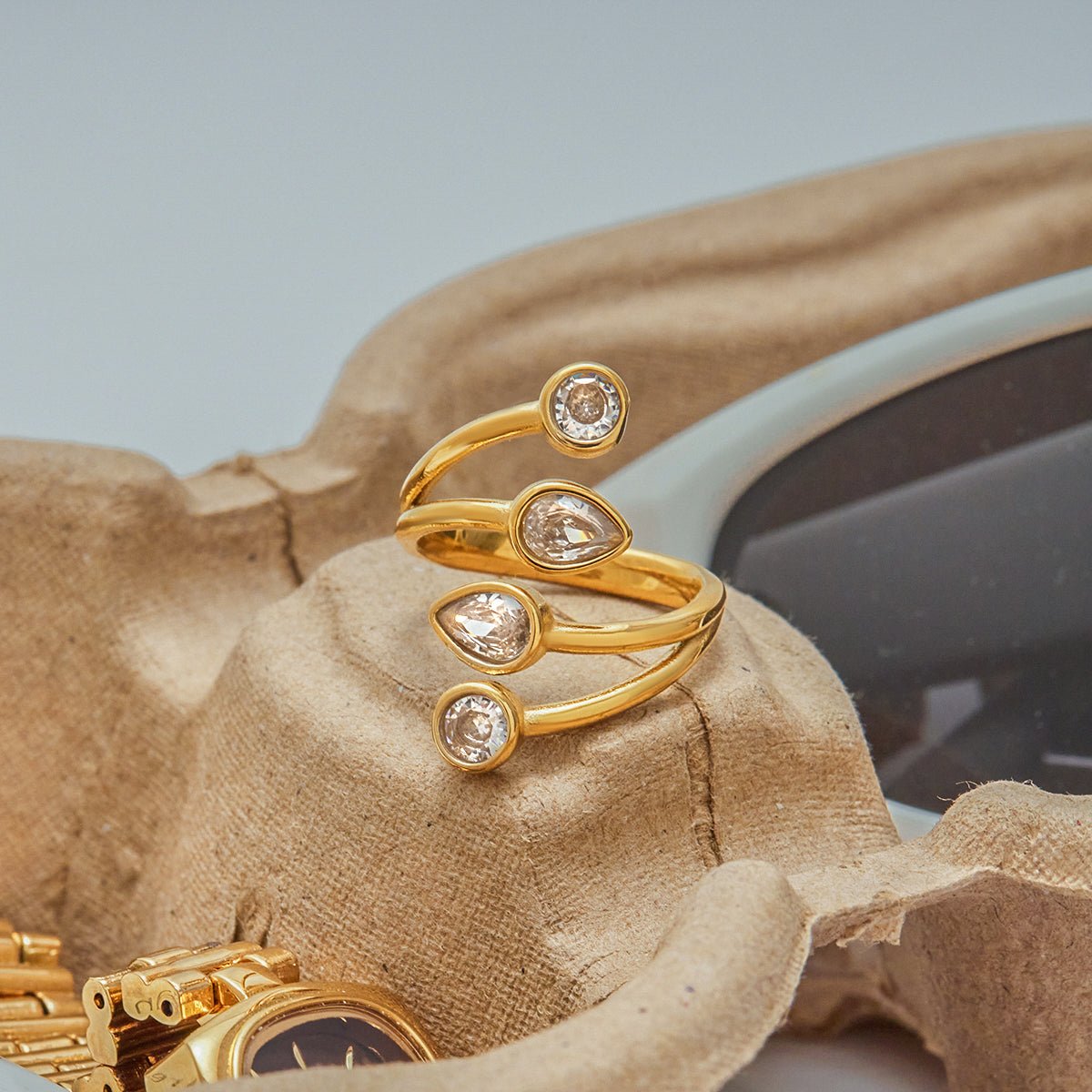 Gold ring with diamond accents on a textured surface