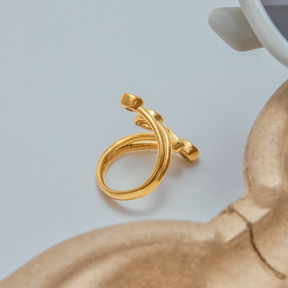 Gold ring on a light gray background Blush and gold adjustable ring for women

