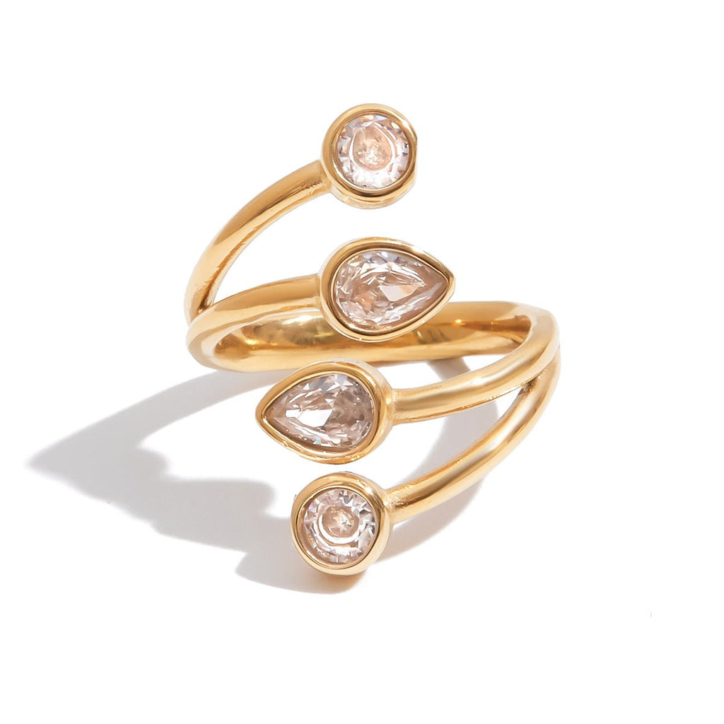 Gold open ring with teardrop-shaped gemstones on a white background
