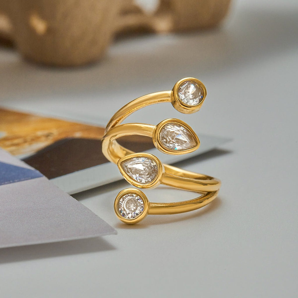 Gold ring with diamond-like stones on a light surface