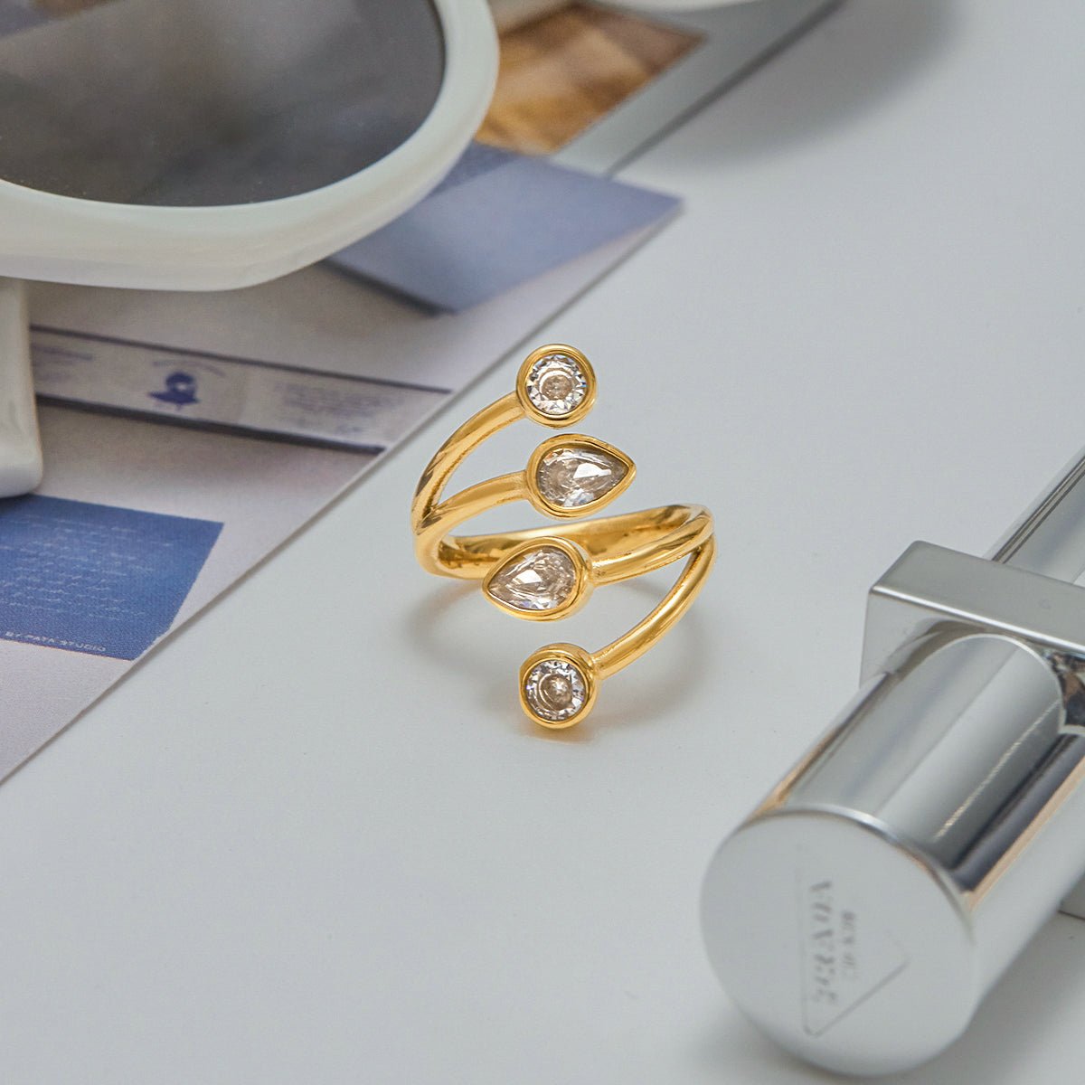 Gold ring with gemstones on a surface with a blurred background