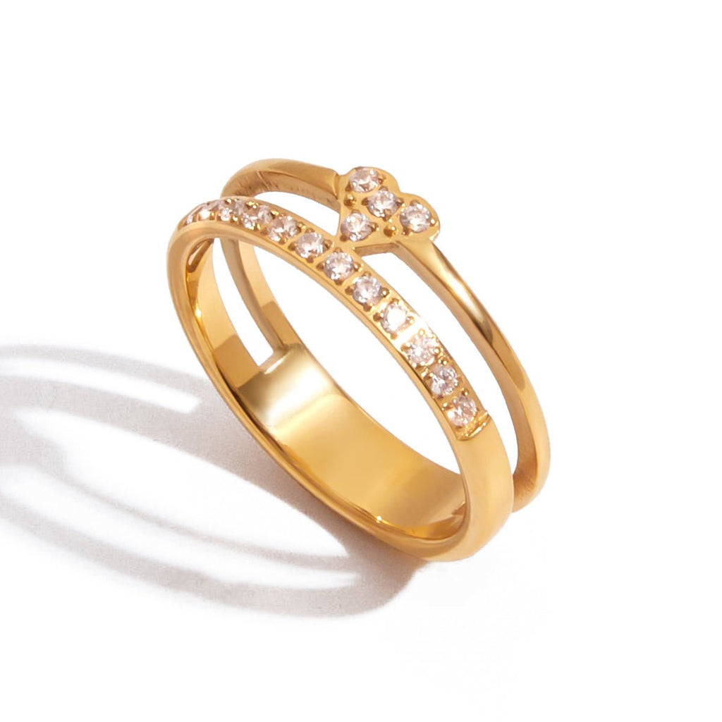 Gold ring with embedded crystals on a white background