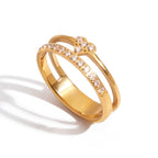 Gold ring with embedded crystals on a white background