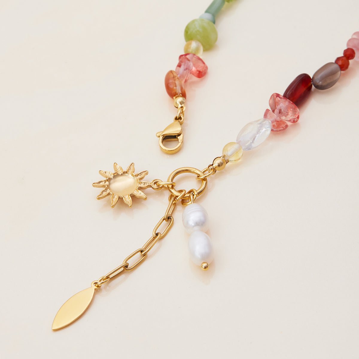 Statement charm bracelet with pearls and gold details

