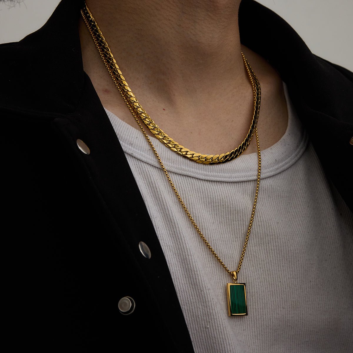 Gold chain necklace with striped green gemstone

