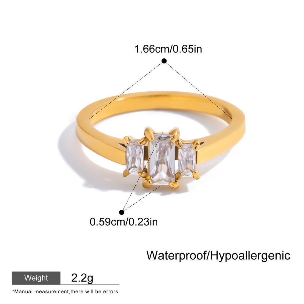 Gold ring with clear gemstone, showing measurements and material details on a white background.