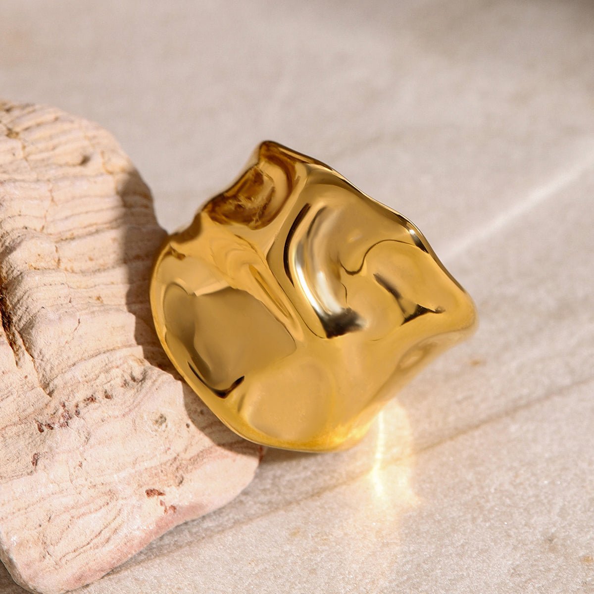 Gold ring with a textured surface on a stone background