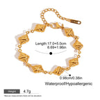 Gold shell bracelet with sculpted textured links

