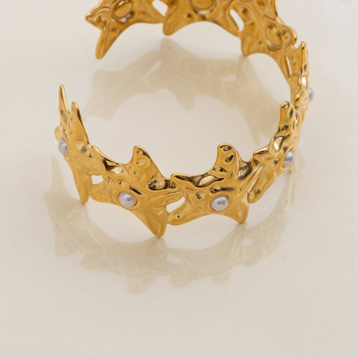 Textured star bracelet with open design in gold