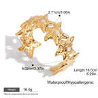 Close-up of gold star cuff with faux pearls