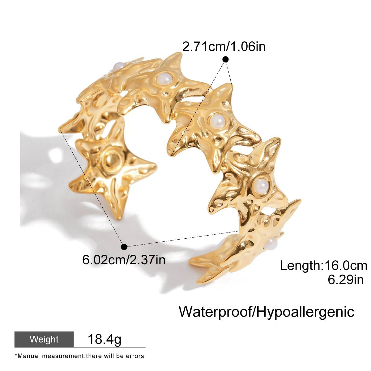 Close-up of gold star cuff with faux pearls