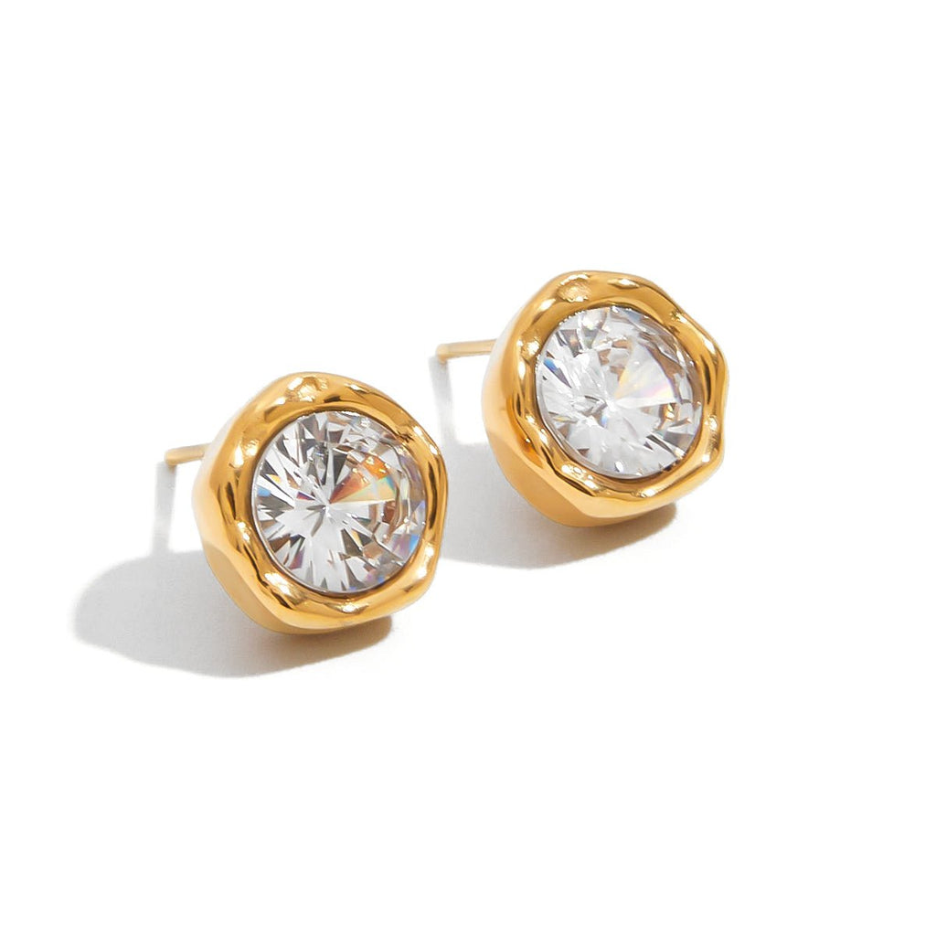 Gold earrings with large clear gemstones on a white background Gift-ready CZ stud earrings in elegant gold

