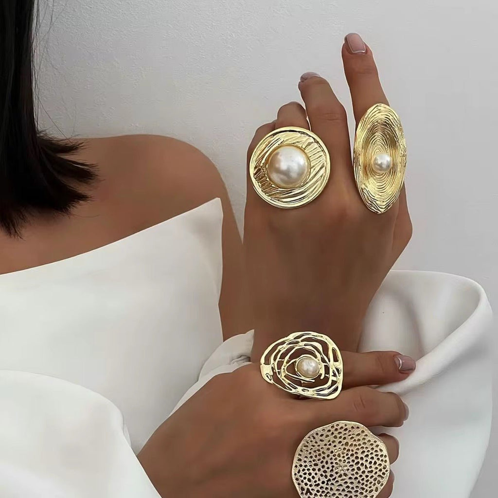Gold rings with pearls on a white background