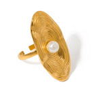 Gold ring with a pearl on a white background