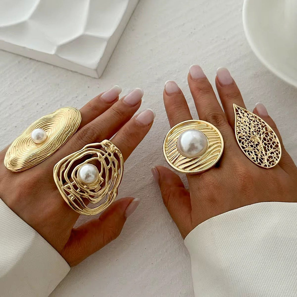 Gold rings with pearls on a neutral background