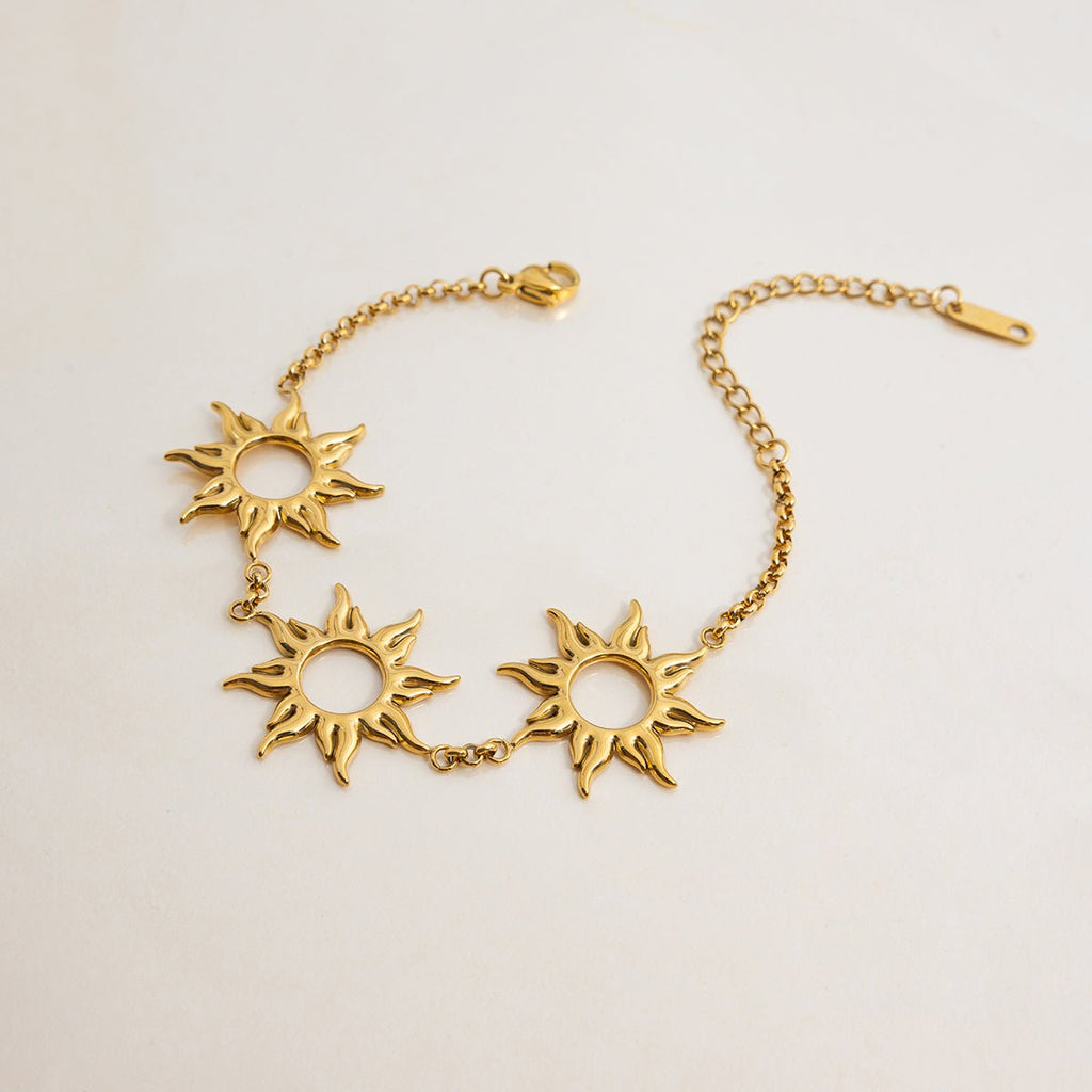 Celestial gold bracelet with radiant sun charms

